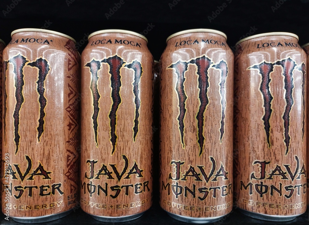 Java Monster energy drink cans lined up on a supermarket shelf with a ...