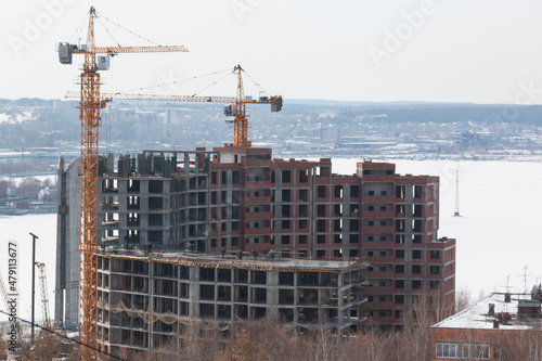 tower crane next to an unfinished house