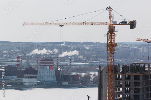 tower crane next to an unfinished house