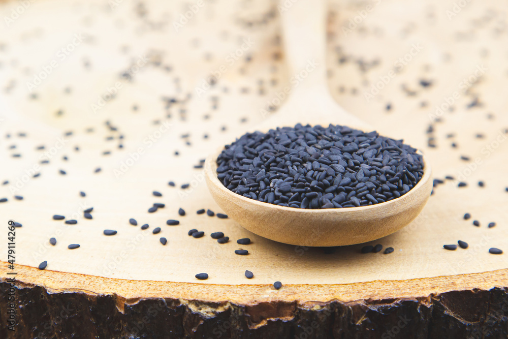 Sesame, Close-up black sesame seeds in a wooden spoon for healthy food and diet concepts. Sesame, Close-up black sesame seeds in a wooden spoon for healthy food and diet concepts.