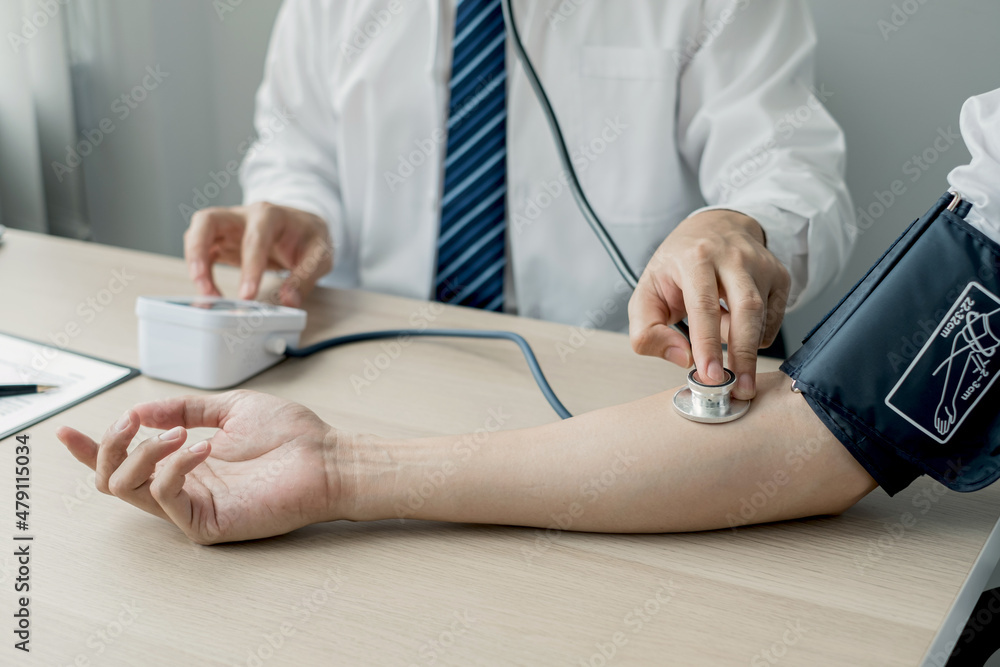 Fototapeta premium Man doctors measured blood pressure, the patient examined the heartbeat, and talked about health care closely. Medical and health care concepts