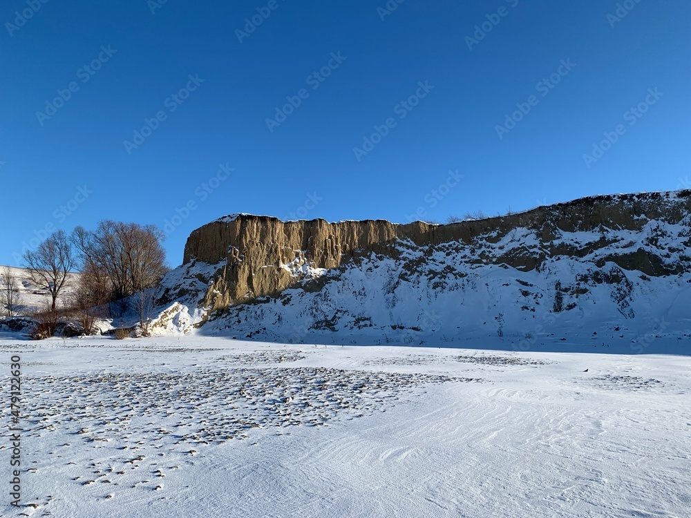 ice covered with snow on the background of snowy hills ice covered with snow on the background of snowy hills