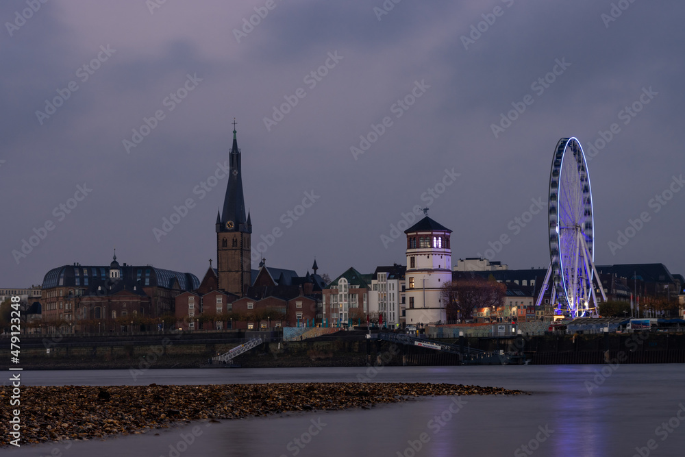 Church, tower and Ferris wheel on the river Rhine