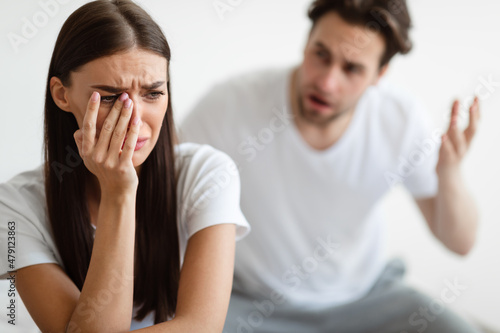 Aggressive Husband Shouting At Unhappy Crying Wife At Home © Prostock-studio