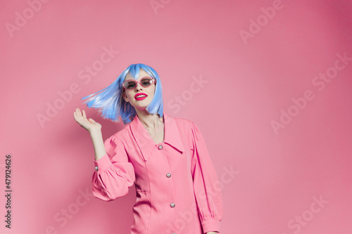 portrait of a woman in blue wig pink dress red lips pink background © SHOTPRIME STUDIO