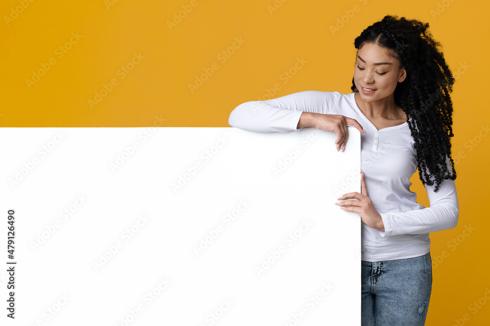 Place For Advertisement. Cheerful African American Woman Standing Next To Blank Billboard Place For Advertisement. Cheerful African American Woman Standing Next To Blank Billboard