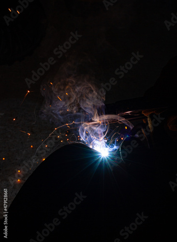 Welding work with an electrode clamp Welding flame during work with many sparks.
