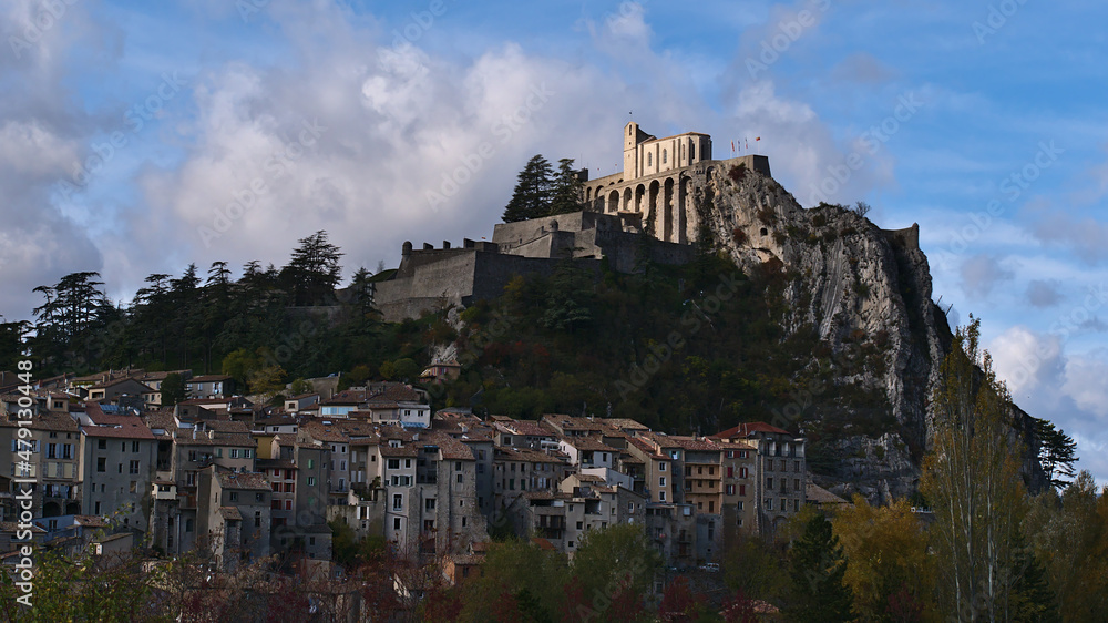 Cityscape of popular town Sisteron in Provence, France with old buildings in the historic center and the famous Citadel located on a rock.