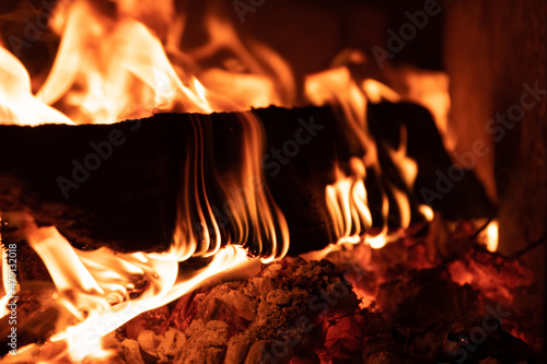 Burning wood in the stove. A comb of flame on burning wood in the fireplace.