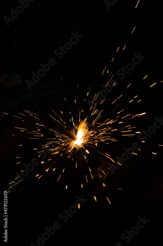 Close-up of welding, Sparks from the welding deode fly away in different directions during operation ..