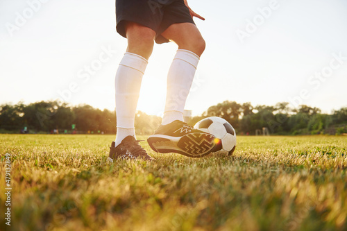 Close up view. Young soccer player have training on the sportive field