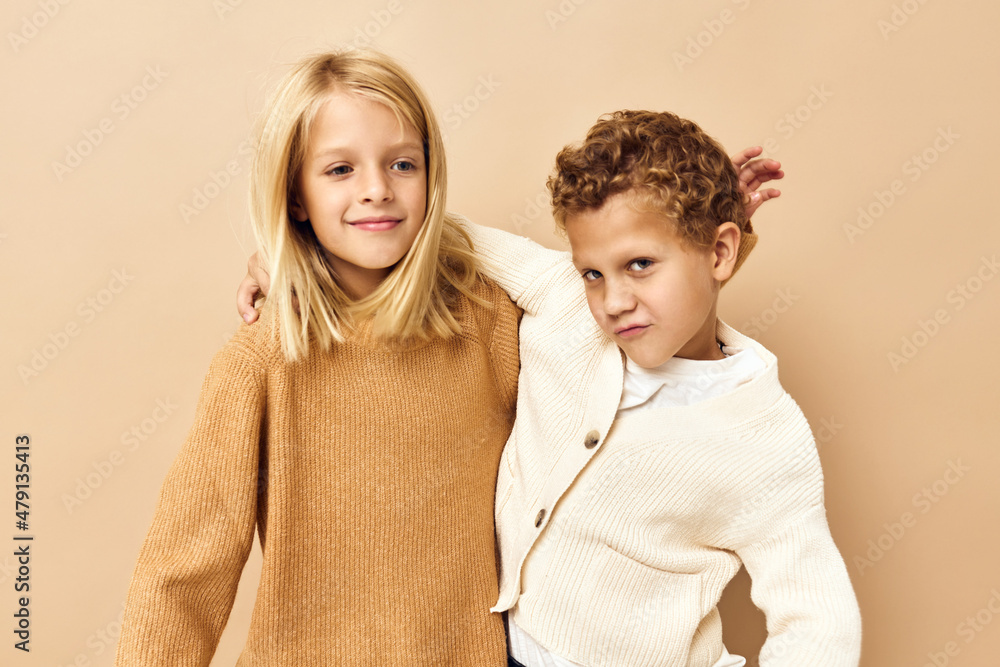 little children smiling and posing in casual clothes beige background little children smiling and posing in casual clothes beige background