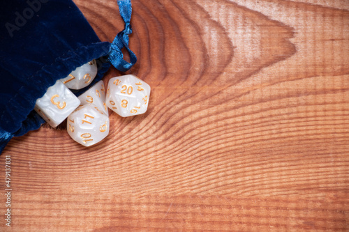 Canvas-taulu Set of role playing white dices in blue  storage bag on a gaming table made of w