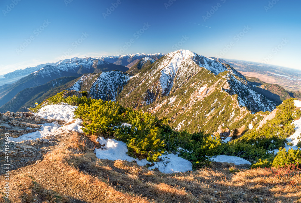Bavarian winter panoramic view across the alps with various mountain peaks in the foreground