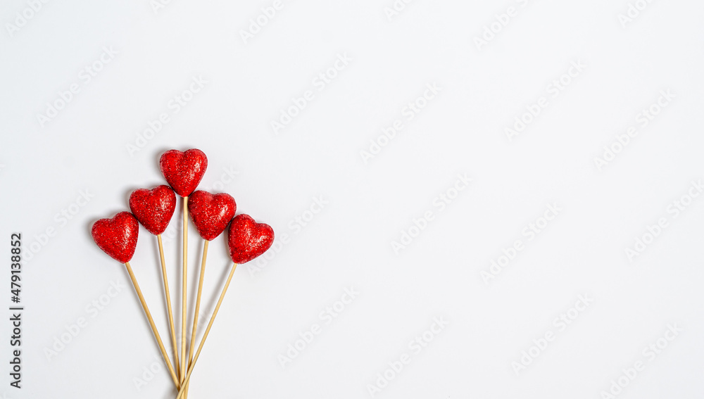 Bouquet of red shiny hearts on a white background