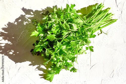 Green juicy parsley on a white background. fresh seasoning