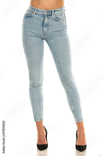 Front view of pretty female legs in jeans and shoes