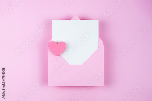 White empty card with copy space in pink envelope on pink background  © Eugenia