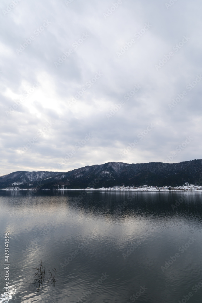 A view of Lake Yogo in Shiga Prefecture in midwinter, with the sky reflecting off the lake surface.