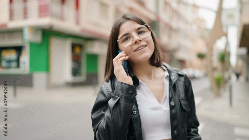 Young hispanic woman smiling confident talking on the smartphone at street Young hispanic woman smiling confident talking on the smartphone at street