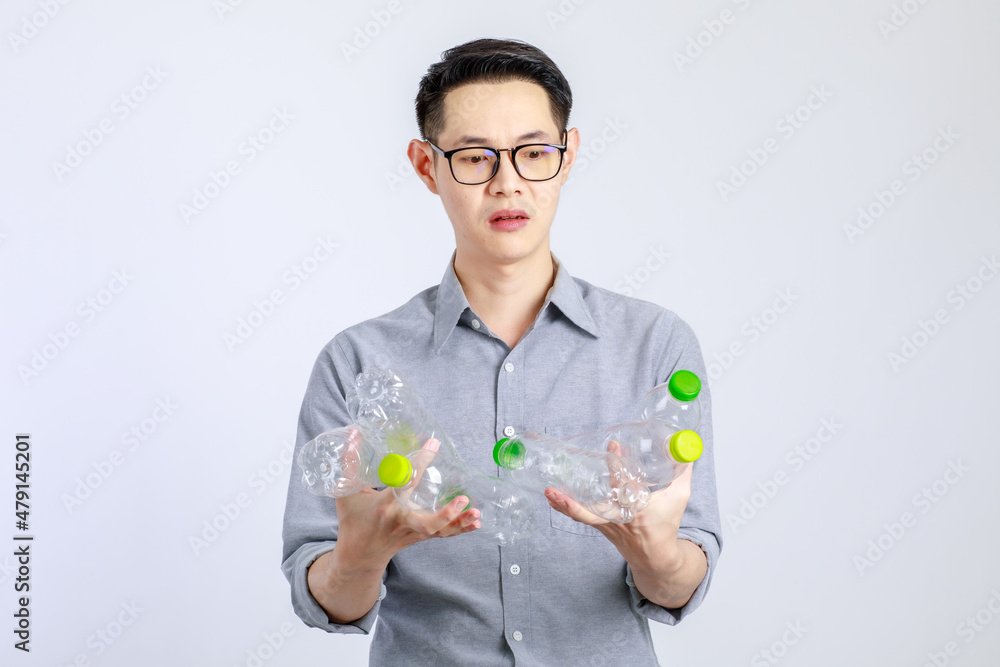 Young, friendly face asian man smile happy, dressed casually campaign say no plastic, reducing plastic, reducing global warming, studio light shot isolated on white background. Environment concept Young, friendly face asian man smile happy, dressed casually campaign say no plastic, reducing plastic, reducing global warming, studio light shot isolated on white background. Environment concept