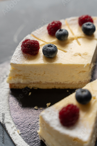 Cheesecake with fresh berries for dessert - healthy organic berry dessert cheesecake. Copy space. Homemade cheese cake. Selective focus. Vertical shot