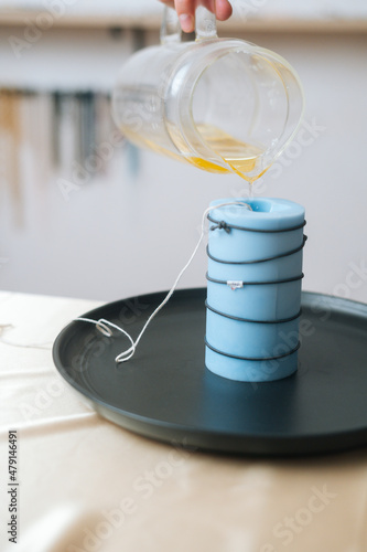 Wallpaper Mural Vertical cropped shot of unrecognizable female artisan pouring yellow liquid wax from glass bowl into silicon mold. Process of making handmade natural candle at workshop. Torontodigital.ca