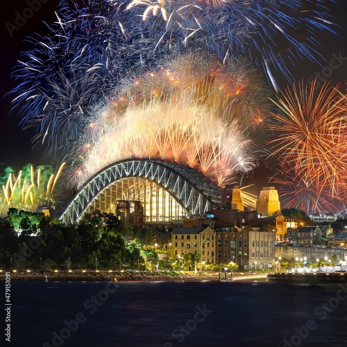 Sydney city harbour bridge illuminated with vivid colours from NYE New Years Eve fireworks NSW Australia 