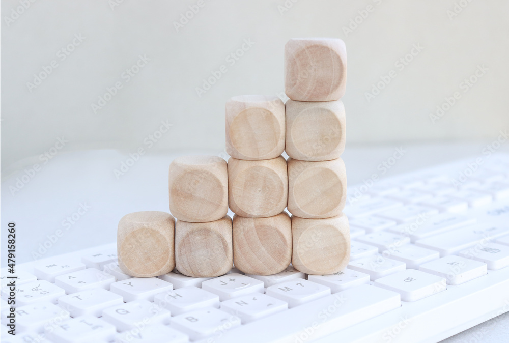 empty wooden cube on placed on the keyboard, copy space empty wooden cube on placed on the keyboard, copy space