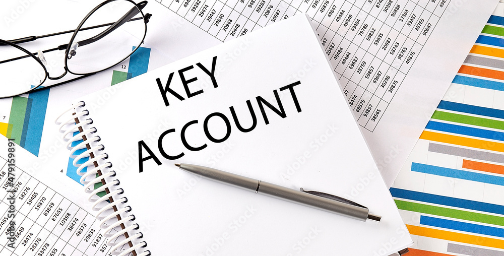 KEY ACCOUNT text , pen and glasses on the chart KEY ACCOUNT text , pen and glasses on the chart