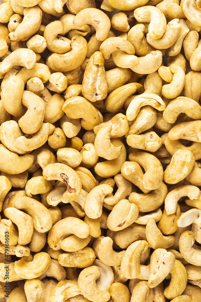 Peeled fresh golden cashew nuts in bulk top view Peeled fresh golden cashew nuts in bulk top view