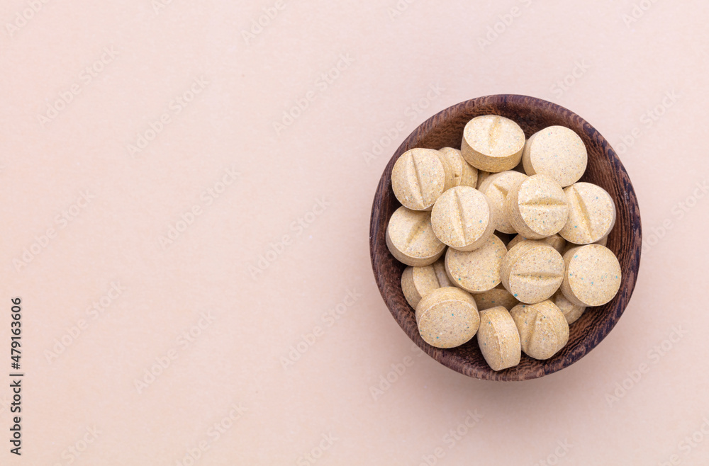 Alternative medicine tablets on a wooden spoon. Alternative medicine tablets on a wooden spoon.