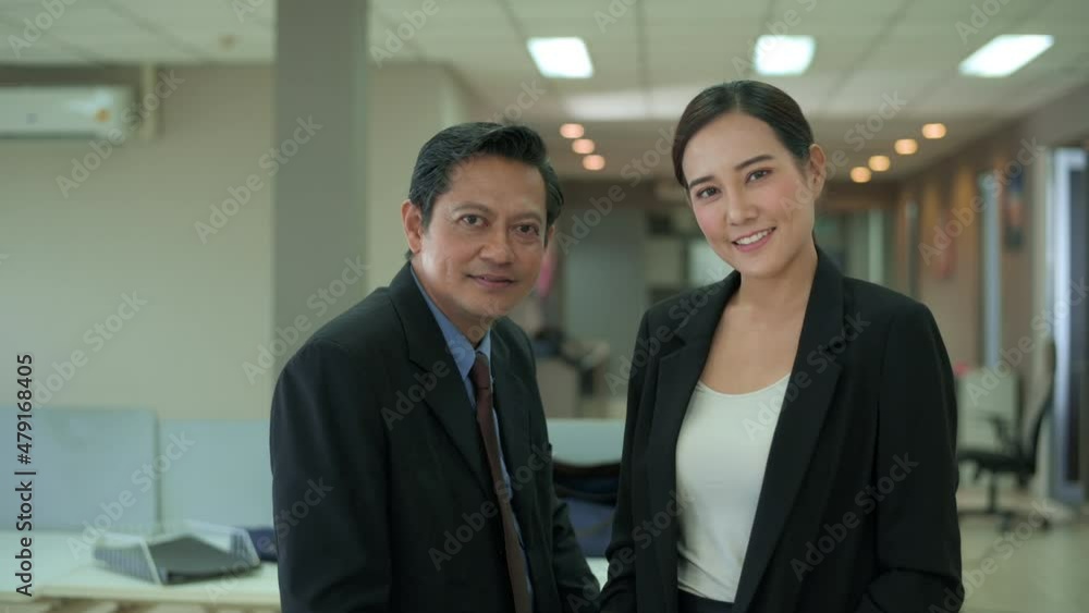 An asian business people are looking camera , confident in office An asian business people are looking camera , confident in office