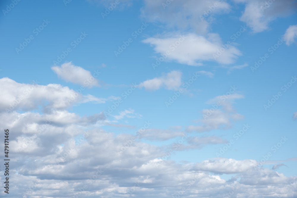Blue sky with white fluffy cumulus clouds. The perfect sky backdrop to replace the sky in your photos