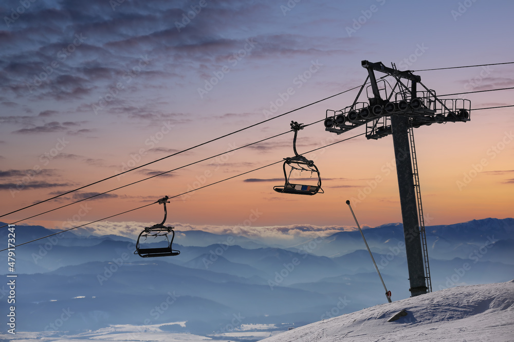 empty chair lift on evening sky background empty chair lift on evening sky background