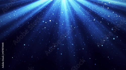 Magic light with flying particles of dust on blue background - 4K video