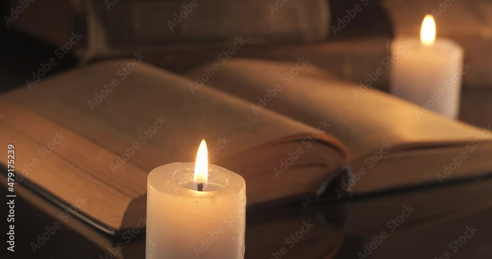 A Burning Candles and an Old Book A Burning Candles and an Old Book