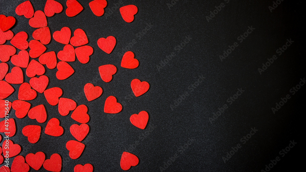Red hearts on a black background. Valentine's Day.