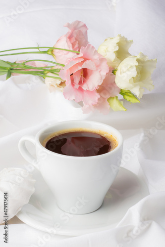 Romantic morning with a cup of coffee. Delicate ambiance of a peaceful morning, showcased by a freshly brewed coffee and gentle floral arrangement, inviting warmth and contemplation in every sip.