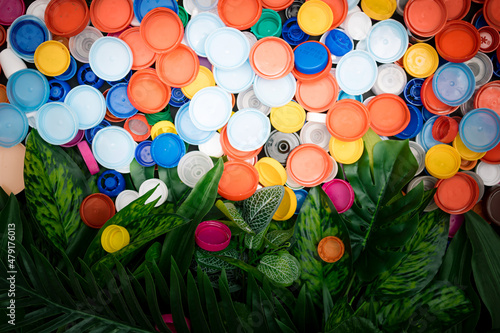 Plastic bottle plugs with green leaves. Save the earth, recycle.Think green!