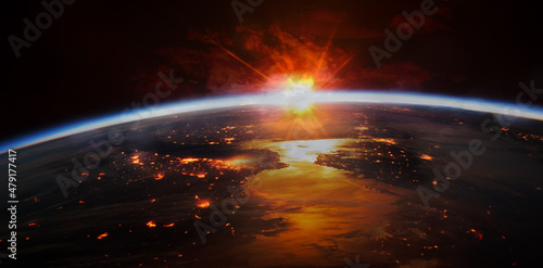 Fototapeta Naklejka Na Ścianę i Meble -  Sunrise reflected in the water, lights of night cities on the ground. Elements of this image furnished by NASA.