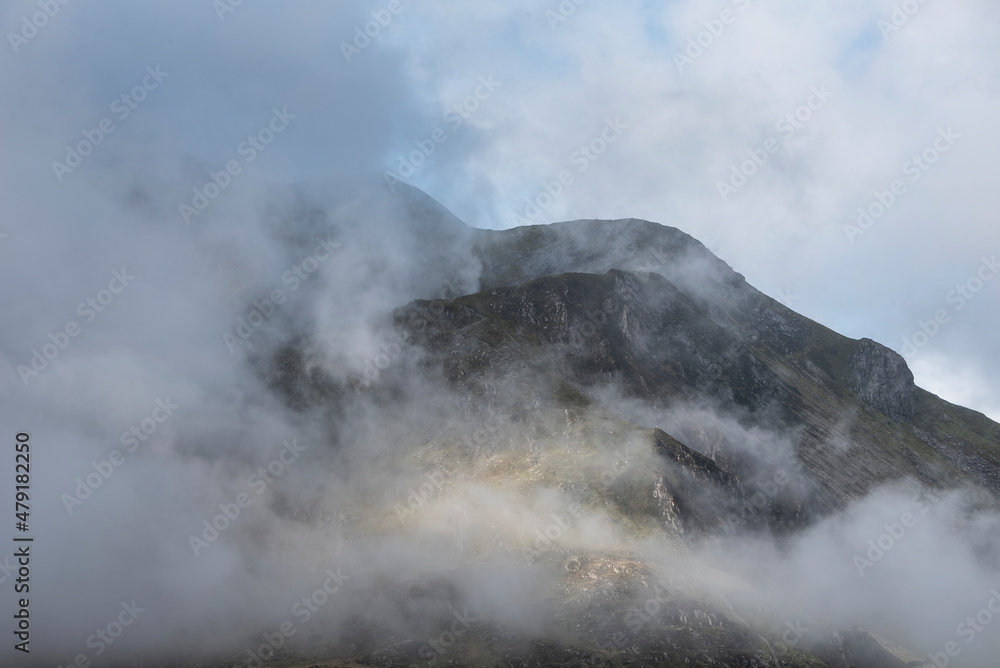 Epic mountain landscape image of Pen Yr Ole Wen in Snowdonia National Park with low cloud on peak and moodyfeel Epic mountain landscape image of Pen Yr Ole Wen in Snowdonia National Park with low cloud on peak and moodyfeel