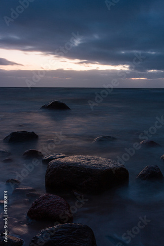 Baltic Sea rocks and beach sand at sunset