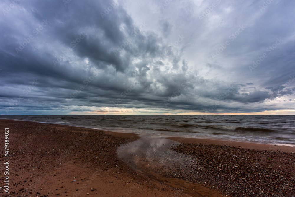 Baltic Sea rocks and beach sand at sunset