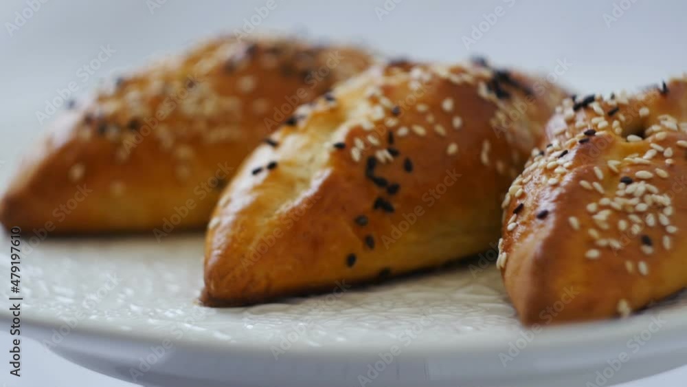 appetizing ruddy cakes sprinkled with sesame seeds close-up parallax appetizing ruddy cakes sprinkled with sesame seeds close-up parallax