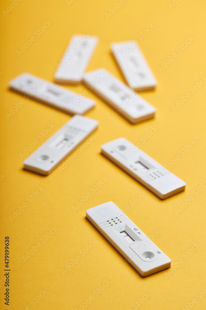 Yellow background with various antigen tests Yellow background with various antigen tests