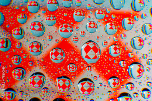 Water droplets on a glass in form of lenses with a colourful background. Wallpaper for screen. Abstract background.