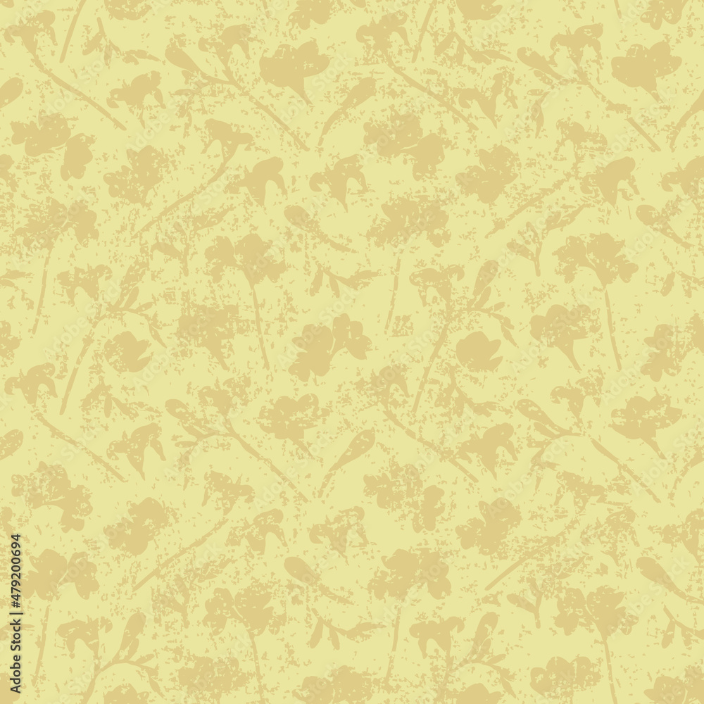 Vintage abstract floral seamless vector pattern with grunge effect. Loosely scattered scratched fading floral silhouettes in soft yellow for wallpaper, curtains, upholstery and fashion fabrics.
