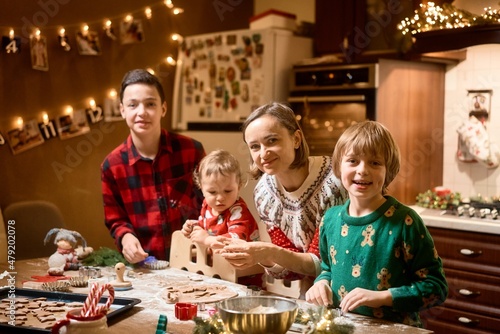 Family with three kids cooking ginger cookies. Merry Christmas, Happy New Year. Family time, preparation for holidays