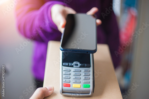 Woman paying using NFC technology